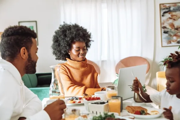 Black family meeting around a table, sharing stories and connecting across generations