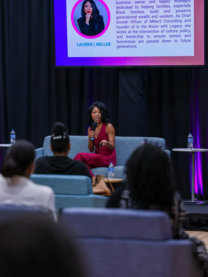 Lauren Miller speaking at an event, sharing legacy wisdom with the audience